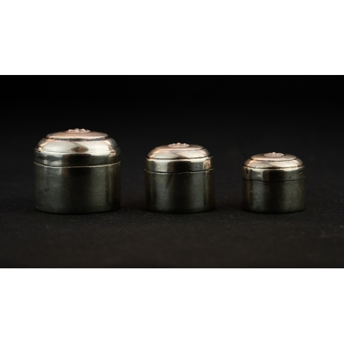 1 - THREE SILVER TRINKET BOXES
 Of cylindrical shape with a domed and pull-off lid, the centre of the li... 