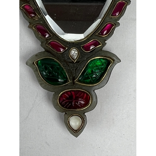 32 - A BEAUTIFUL GEM INSET JADE MIRROR, INDIA
Of inverted triangle form, inlaid with rubies and emeralds ... 