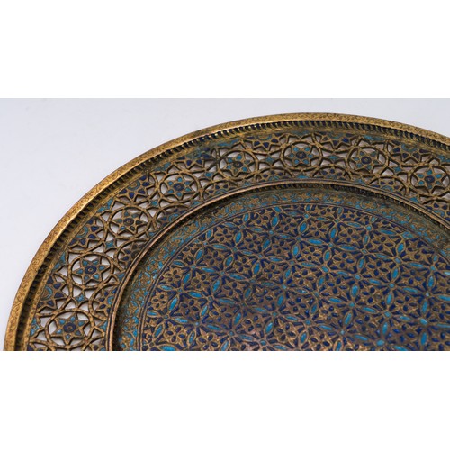 105 - AN OTTOMAN GILTED TRAY, TOMBAK, KUTAHYA,  EARLY 19TH CENTURY

Of circular form, the central field an... 