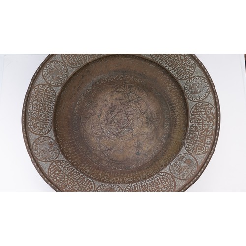 103 - A LARGE AND FINE BRASS DISH WITH ENGRAVED DECORATION, PERSIAN OR MAMLUK
Of circular form with a broa... 