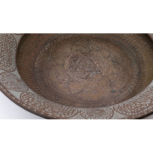 103 - A LARGE AND FINE BRASS DISH WITH ENGRAVED DECORATION, PERSIAN OR MAMLUK
Of circular form with a broa... 