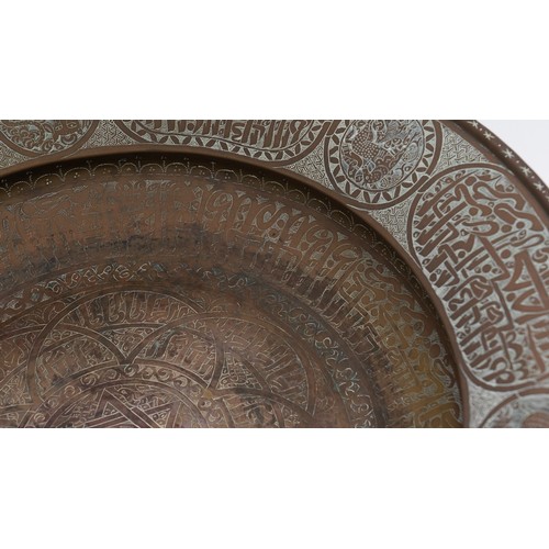 103 - A LARGE AND FINE BRASS DISH WITH ENGRAVED DECORATION, PERSIAN OR MAMLUK
Of circular form with a broa... 