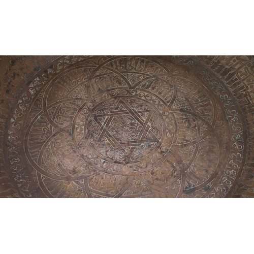 103 - A LARGE AND FINE BRASS DISH WITH ENGRAVED DECORATION, PERSIAN OR MAMLUK
Of circular form with a broa... 