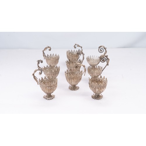 78 - A SET OF NINE SILVER TELKARI ZARF, SALT CELLARS

Each crafted in the form of a blossoming flower, th... 