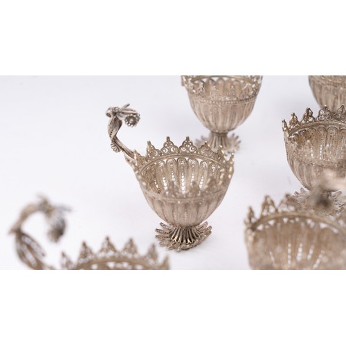 78 - A SET OF NINE SILVER TELKARI ZARF, SALT CELLARS

Each crafted in the form of a blossoming flower, th... 