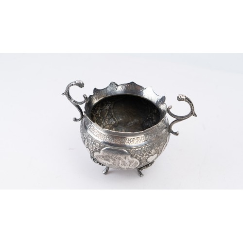 76 - QAJAR SILVER BOWL, ISFAHAN

With scalloped rim on four cast foliate feet, with twin handles; decorat... 