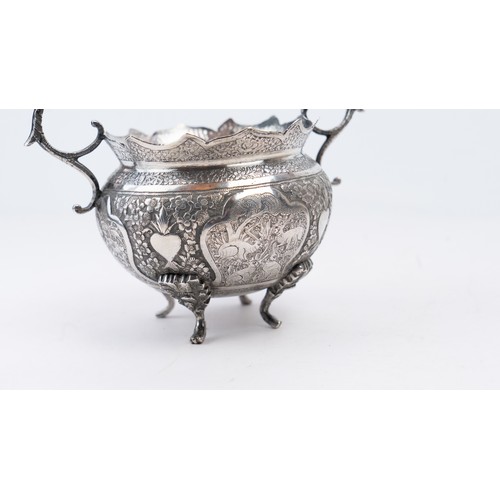 76 - QAJAR SILVER BOWL, ISFAHAN

With scalloped rim on four cast foliate feet, with twin handles; decorat... 