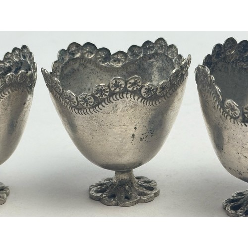 52 - THREE SILVER COFFEE CUPS, OTTOMAN EMPIRE

Each raised on a scalloped circular foot, the plain taperi... 