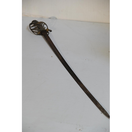 191 - Brass handled sword in scabbard and ceremonial sword with royal motive (39