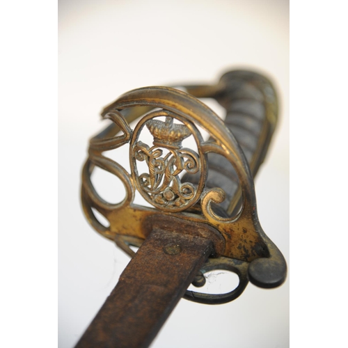 191 - Brass handled sword in scabbard and ceremonial sword with royal motive (39