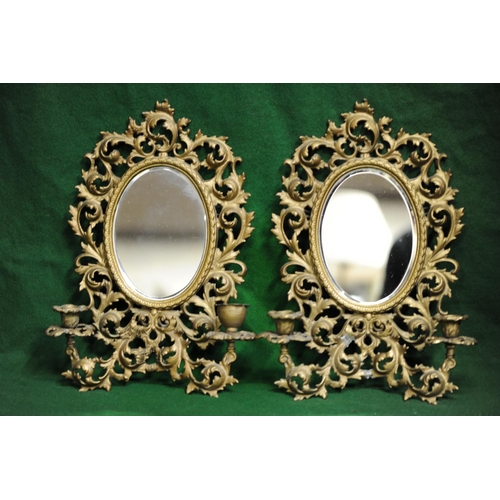 195 - Pair of ornate brass oval bevelled glass wall mirrors with candle sconces (16