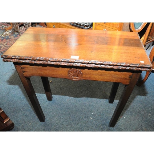 205 - Mahogany fold-over tea table with carved frieze on square legs (30