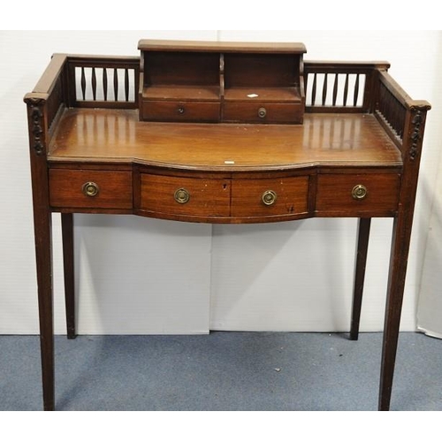 104 - Edwardian Mahogany bow fronted Desk with gallery top on tapered legs.