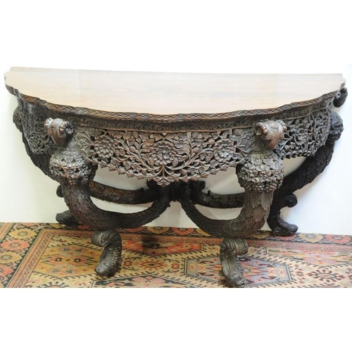 165 - Rosewood 19th. Century Anglo Indian  Console Table with profusely carved frieze surmounted by  Ram's... 