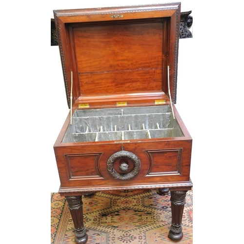 180 - French Mahogany carved Cellarette with lead line fitted interior on turned legs with brass castors. ... 