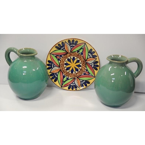 33 - Pair of large green China Pitchers and a coloured China Plaque