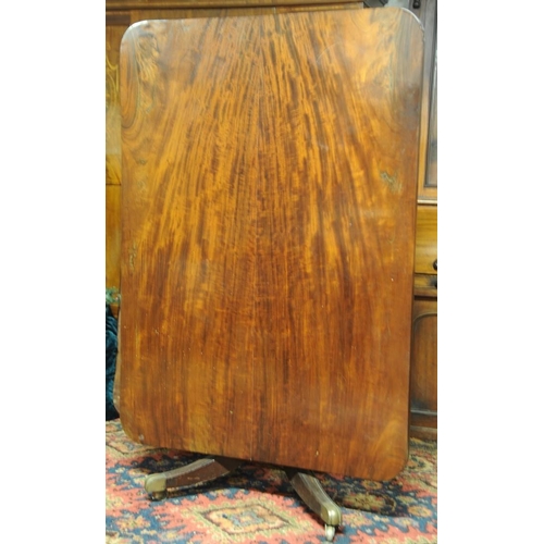 258 - William IV Mahogany Breakfast Table on carved baluster pod on four splayed legs with brass castors.