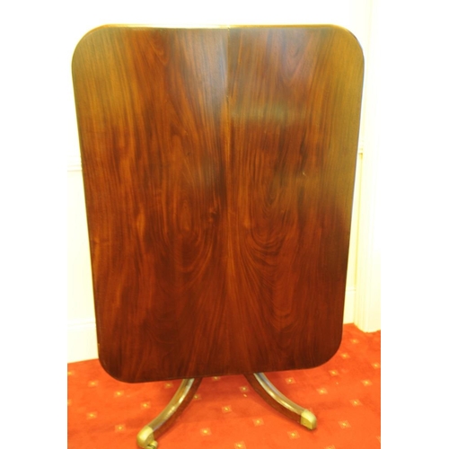 262 - Regency Mahogany Breakfast Table on four splayed legs with brass castors.