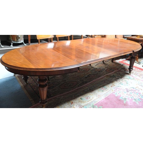 121 - Victorian Mahogany Oval ended Dining room Table with three extra leaves on turned legs extending to ... 