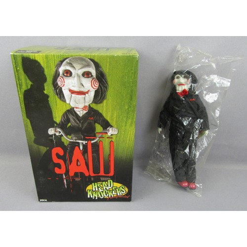 61 - NECA / REEL TOYS 9” Plush ‘SAW’ Billy the Puppet Doll, in unopened bag, plus Head Knockers Hand-pain... 