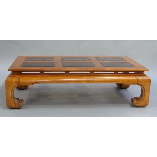 196 - A Chinese design elm coffee table inset with six bevelled glass panels and on a moulded apron and le... 