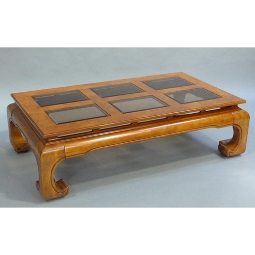 196 - A Chinese design elm coffee table inset with six bevelled glass panels and on a moulded apron and le... 