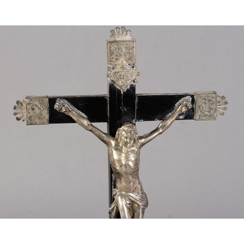 249 - A FRENCH OR ITALIAN SILVER AND EBONISED WOOD CRUCIFIX, on a bombe-shaped stand with bun feet, 30.5cm... 