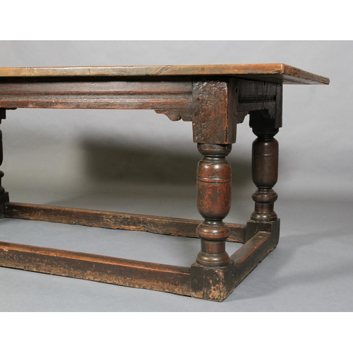 621 - A LATE 17TH CENTURY OAK REFECTORY TABLE, having a planked surface with cleat ends, moulded apron wit... 