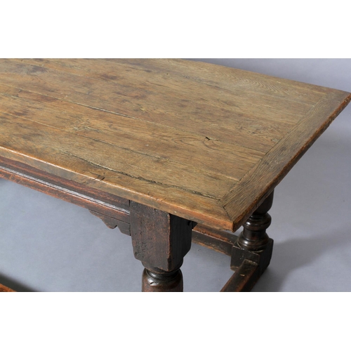 621 - A LATE 17TH CENTURY OAK REFECTORY TABLE, having a planked surface with cleat ends, moulded apron wit... 