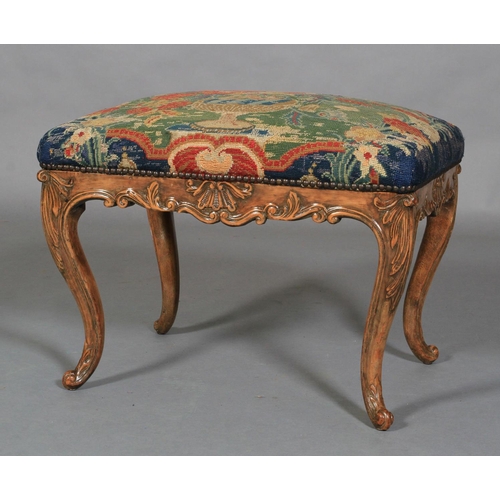 622 - A REGENCY STYLE STOOL IN WALNUT AND BEECH, rectangular, having a needlework upholstered seat, shell ... 