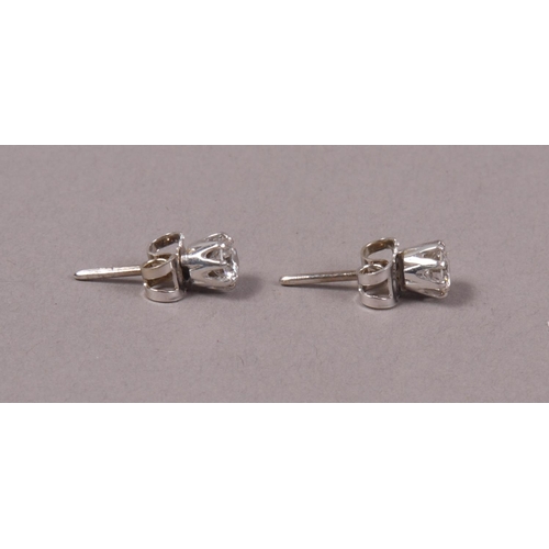 318 - A PAIR OF DIAMOND STUD EARRINGS, the brilliant cut stones each in crown setting in white metal (test... 