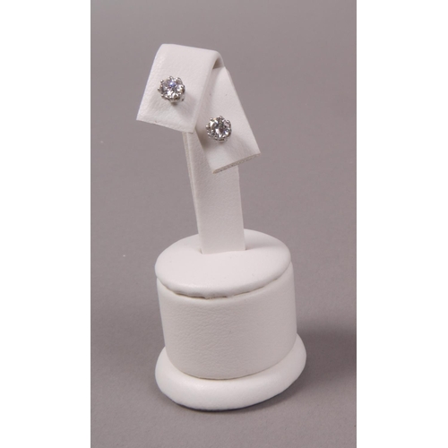 318 - A PAIR OF DIAMOND STUD EARRINGS, the brilliant cut stones each in crown setting in white metal (test... 