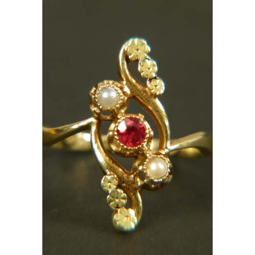 368 - AN EARLY 20TH CENTURY GARNET AND SEED PEARL DRESS RING in 18ct gold, collet set within an open folia... 