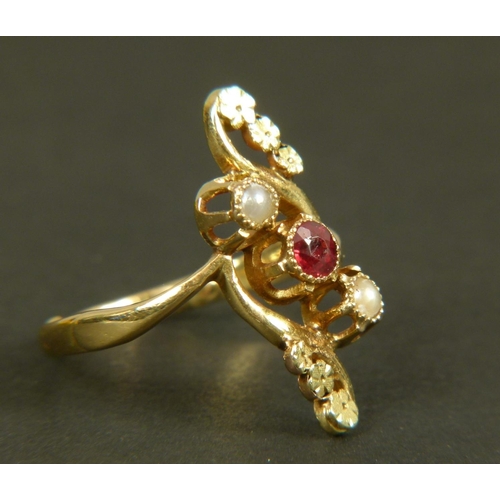 368 - AN EARLY 20TH CENTURY GARNET AND SEED PEARL DRESS RING in 18ct gold, collet set within an open folia... 