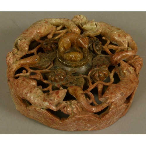 100 - A CHINESE CARVED SOAPSTONE INKWELL, the shallow cylindrical body pierced and carved with foxes, flow... 