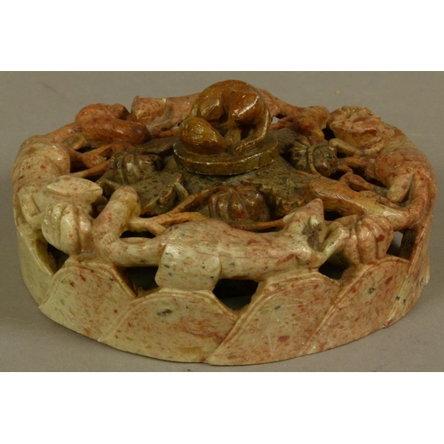 100 - A CHINESE CARVED SOAPSTONE INKWELL, the shallow cylindrical body pierced and carved with foxes, flow... 