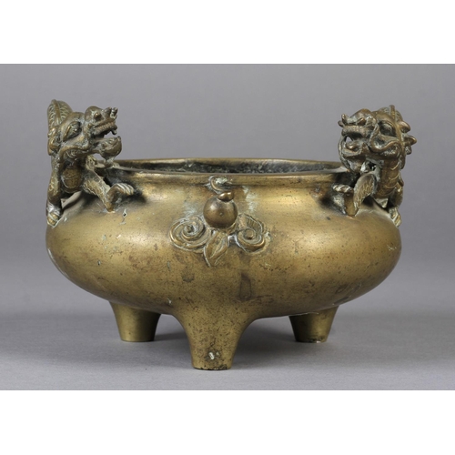 106 - A CHINESE BRONZE TWO HANDLED CENSER of compressed cauldron form, the handles formed as sinuous drago... 