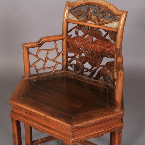 107 - A CHINESE ELM ELBOW CHAIR, the arched back with panelled top carved with fan shaped panel of figure ... 