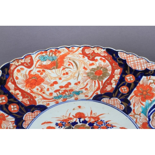 109 - A PAIR OF JAPANESE IMARI CHARGERS c.1880, the circular fluted borders painted in typical palette to ... 