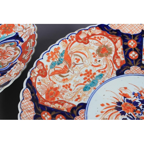 109 - A PAIR OF JAPANESE IMARI CHARGERS c.1880, the circular fluted borders painted in typical palette to ... 