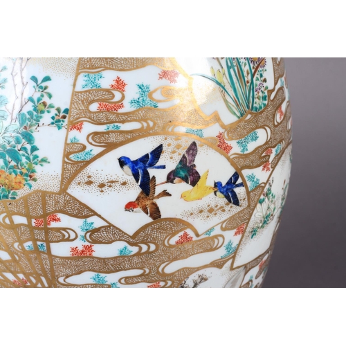 110 - A JAPANESE VASE c.1900 of baluster form painted with flowers, birds and pavilions in shaped panels, ... 