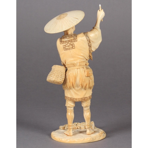 112 - A FINE JAPANESE IVORY OKIMONO OF A FISHERMAN, standing on a rock, a fishing net pegged down in the s... 