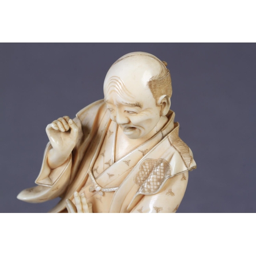 114 - A JAPANESE IVORY OKIMONO OF A MAN, startled and frightened by a dog as it bares its teeth at him, a ... 