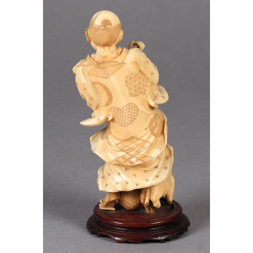 114 - A JAPANESE IVORY OKIMONO OF A MAN, startled and frightened by a dog as it bares its teeth at him, a ... 