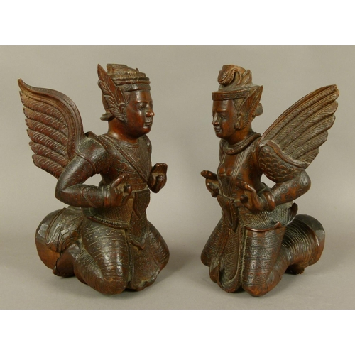 124 - A PAIR OF BURMESE/THAI CARVED HARDWOOD MALE AND FEMALE DEITY, late 19th/early 20th century, the wing... 