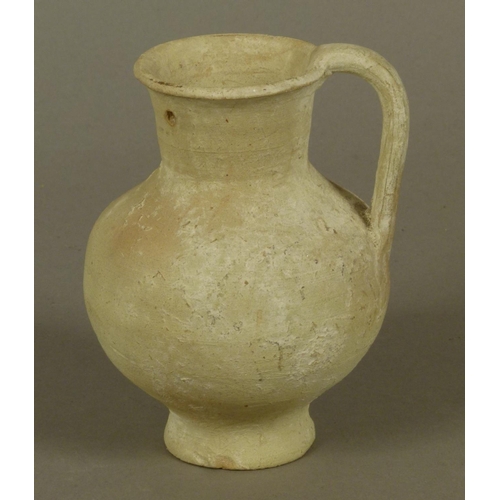 130 - AN ANCIENT GREEK OR SOUTHERN MEDITERRANEAN SMALL PALE TERRACOTTA JUG of bellied form with slightly f... 