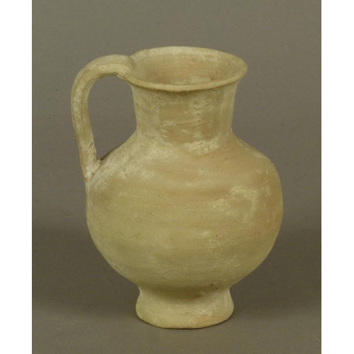 130 - AN ANCIENT GREEK OR SOUTHERN MEDITERRANEAN SMALL PALE TERRACOTTA JUG of bellied form with slightly f... 