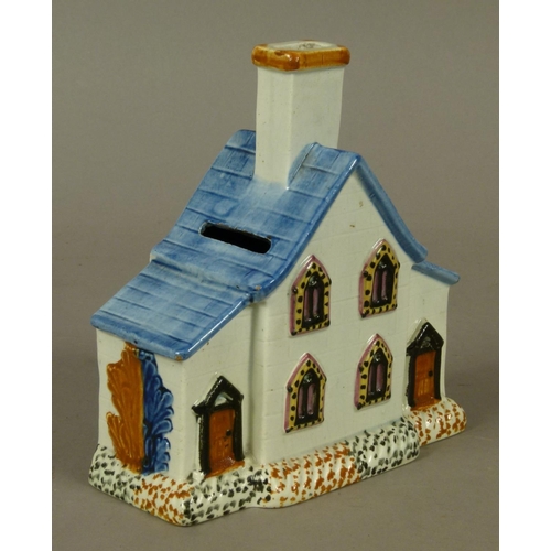 142 - A 19TH CENTURY STAFFORDSHIRE PRATTWARE COTTAGE MONEY BOX, having four lancet-shaped windows flanked ... 