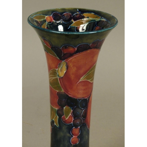 186 - A WILLIAM MOORCROFT POMEGRANATE DESIGN VASE, c.1916, cylindrical with a flared neck and foot, tubeli... 