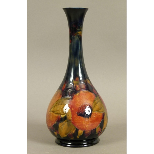 189 - A WILLIAM MOORCROFT POMEGRANATE VASE c.1916, the bottle shape with flared rim and on foot rim, tubel... 